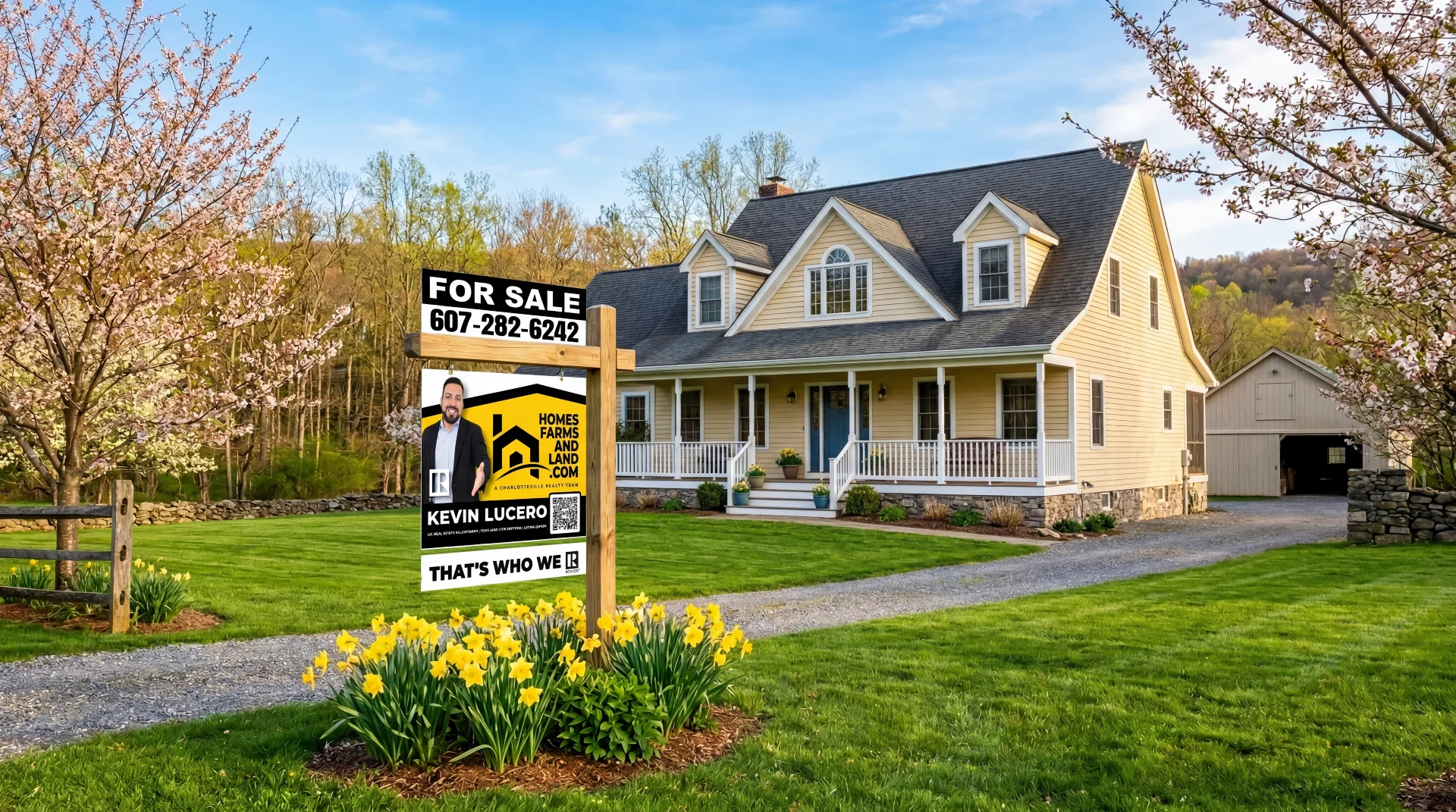 For Sale sign surrounded by spring daffodils in front of a country home