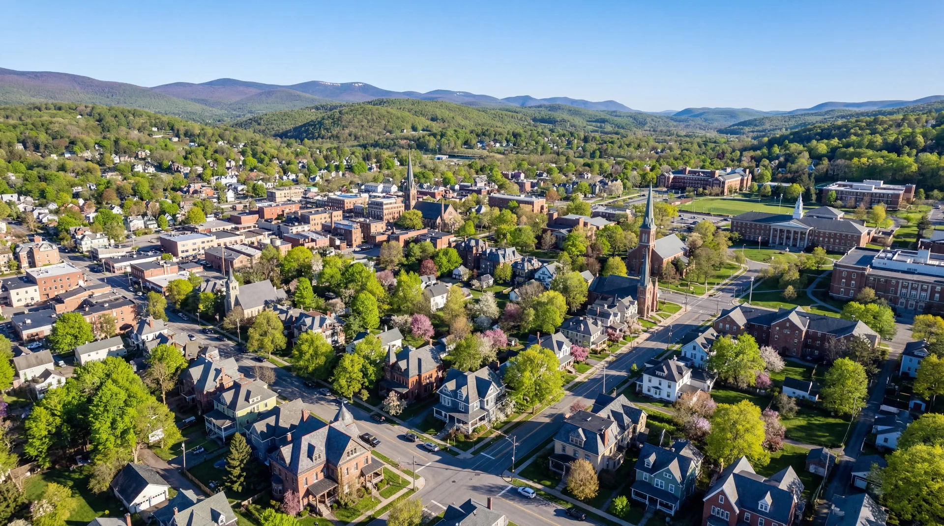 Panoramic view of Oneonta valley on a bright spring morning with rolling green hills and the City of the Hills below
